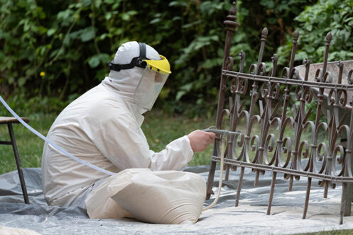 Picture of a tradesperson repairing a metal railing