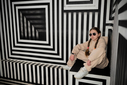 Picture of a mixed striped pattern in black and white with girl seated 