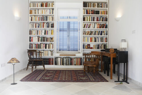 Picture of a small room with two floor to ceiling bookshelves