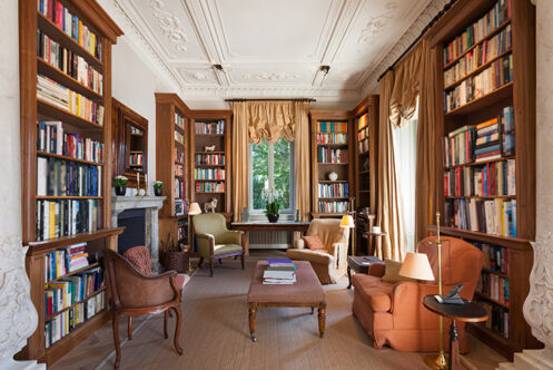 Picture of a home library with multiple facing bookshelves
