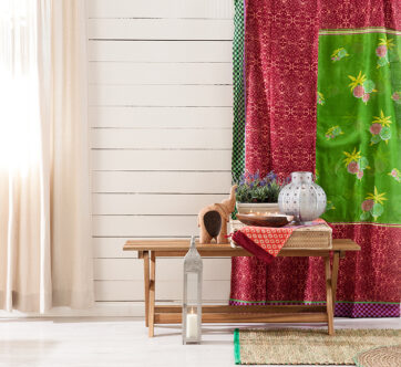 Picture of a low bench with wooden wall and colourful curtain