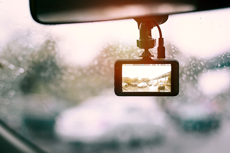 Photo of a camera in a car recording the traffic jam on a rainy day