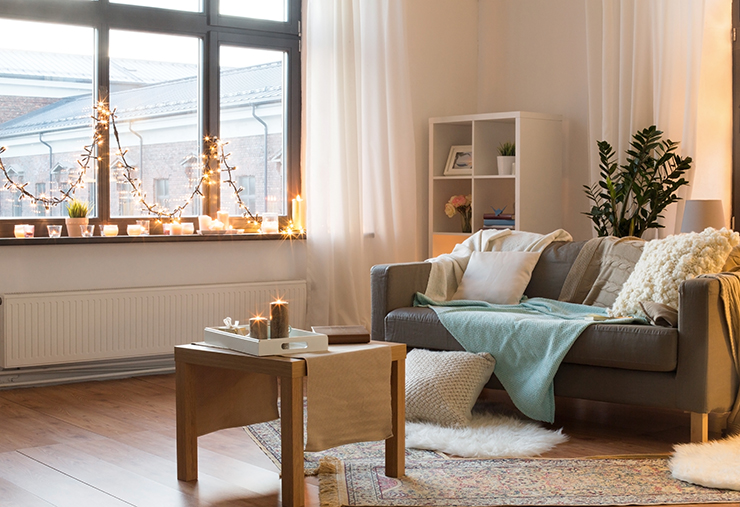 Picture of a living room with fairy lights and lit candles