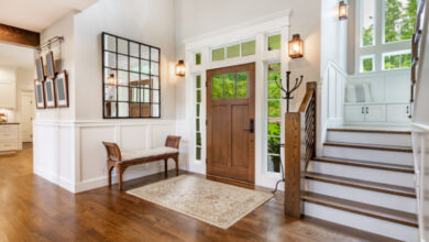 Picture of a front door and hallway with wooden staircase