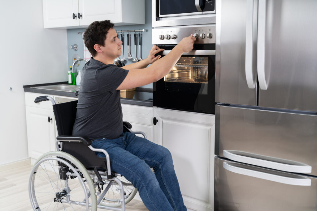 Picture of a man in a wheelchair using a lowered oven