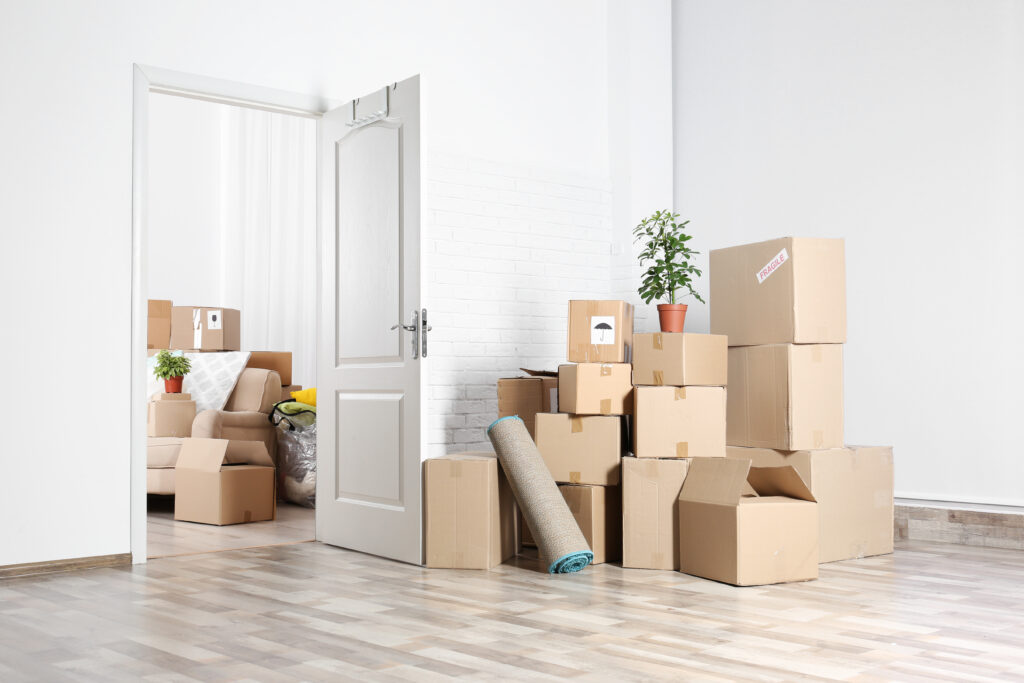 Picture of stacked boxes in an empty room during a move