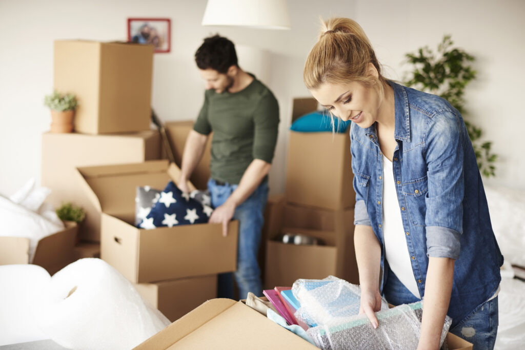 Picture of a man and a woman packing things into boxes for a move
