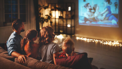 Picture of a home cinema room with people sitting on a couch watching