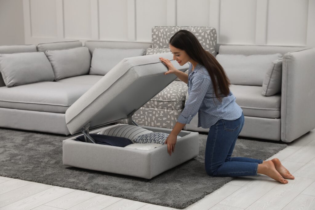Picture of a woman opening sofa to access storage inside 