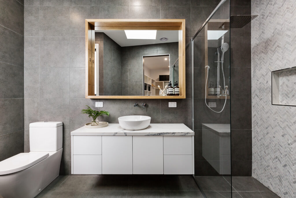 Picture of a bathroom with large window and grey walls