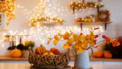 Picture of a a countertop with autumnal decorations like pumpkins and autumn leaves