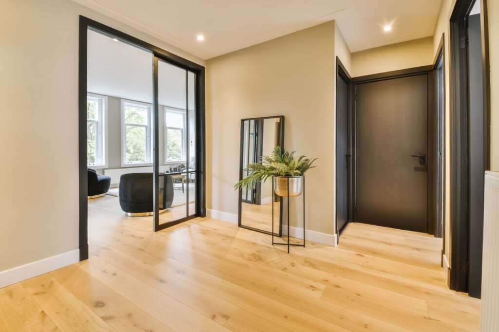 Picture of a hallway with wooden floors and internal glass doors