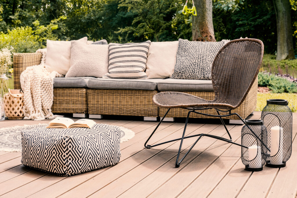 Picture of an outdoor garden chair on wooden deck next to sofa