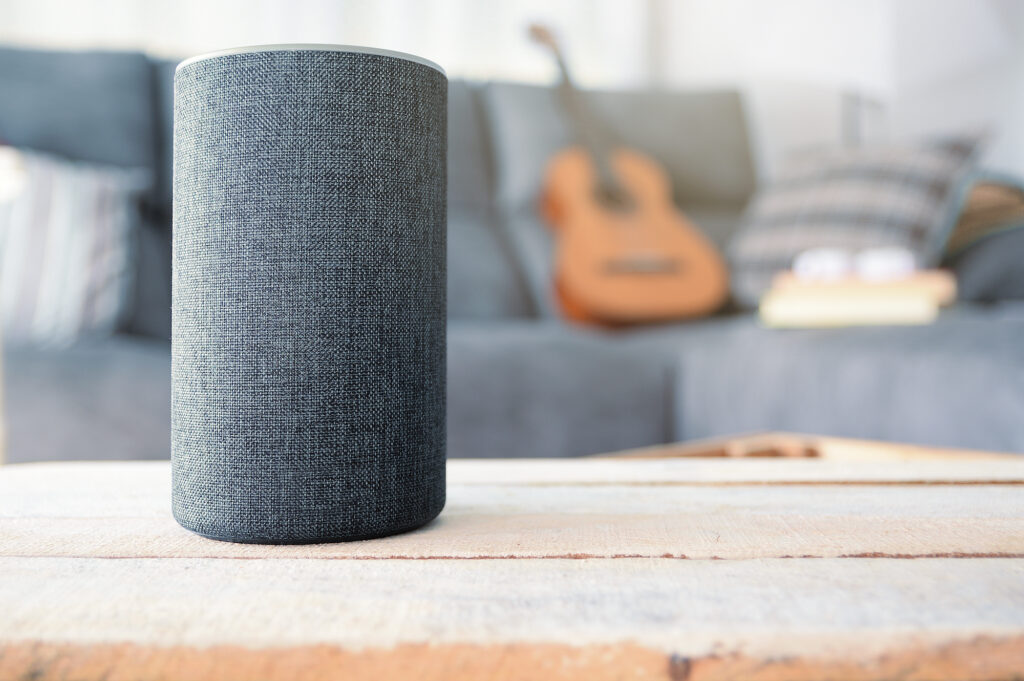 Picture of an Amazon Alexa personal assistant speaker on wooden table 