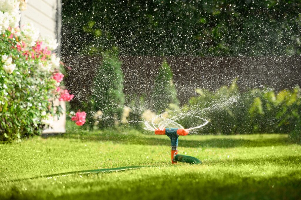 Picture of a garden irrigation system watering the garden lawn and plants